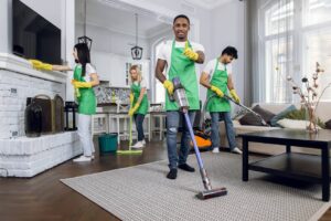 four-multicultural-janitors-doing-cleaning-at-room